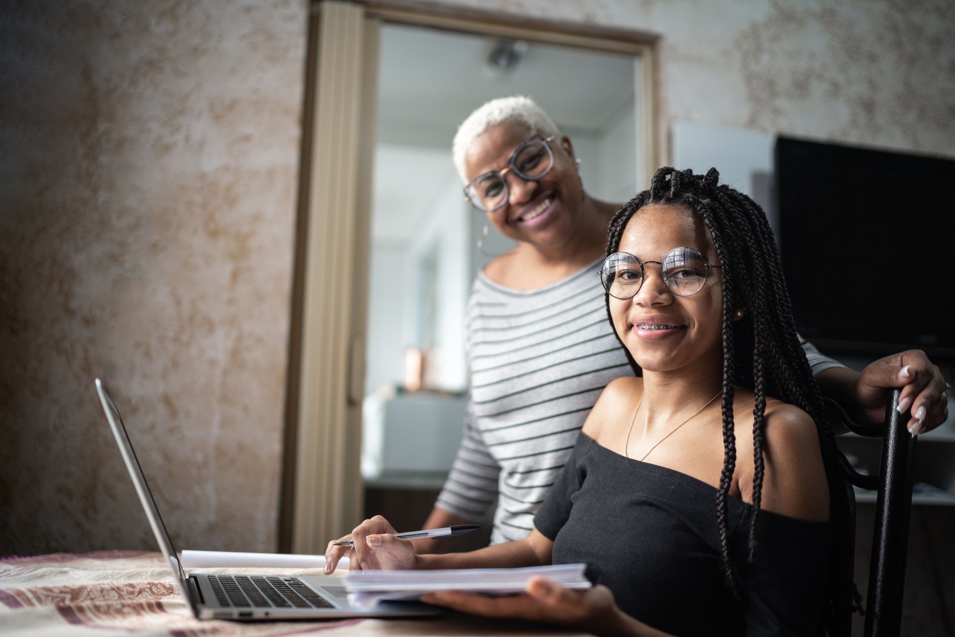 Portrait of a mother and daughter studying with laptop on a online class at home